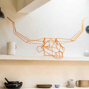 Bend Goods has a variety of animal decor pieces. Seen here is a Long Horn neatly displayed in a kitchen on a shelf. Its decor made to be wall art or home decor.